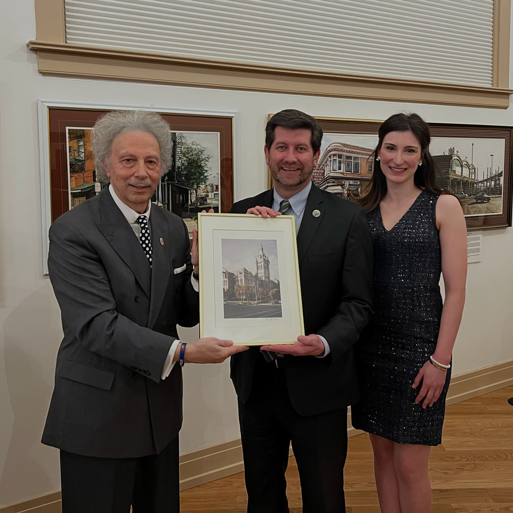 Mark C. Poloncarz holds art with CCI board members