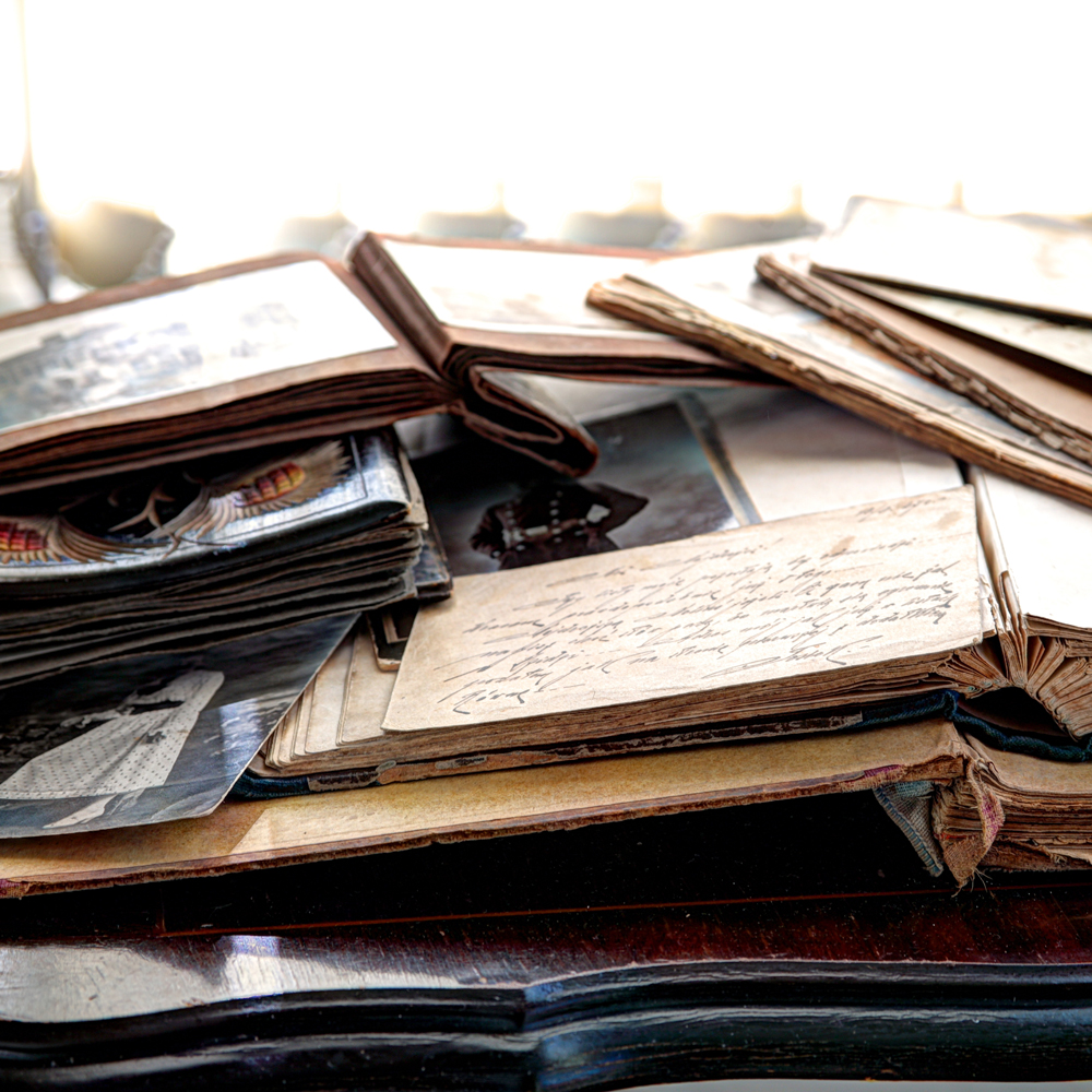 Piles of antiqued photo albumns and notes